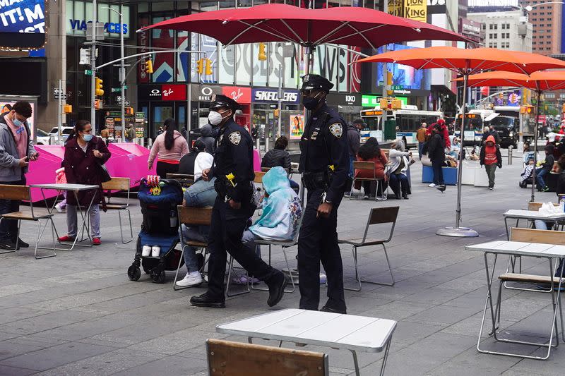 FILE PHOTO: Police officers walk through Times Square in New York City