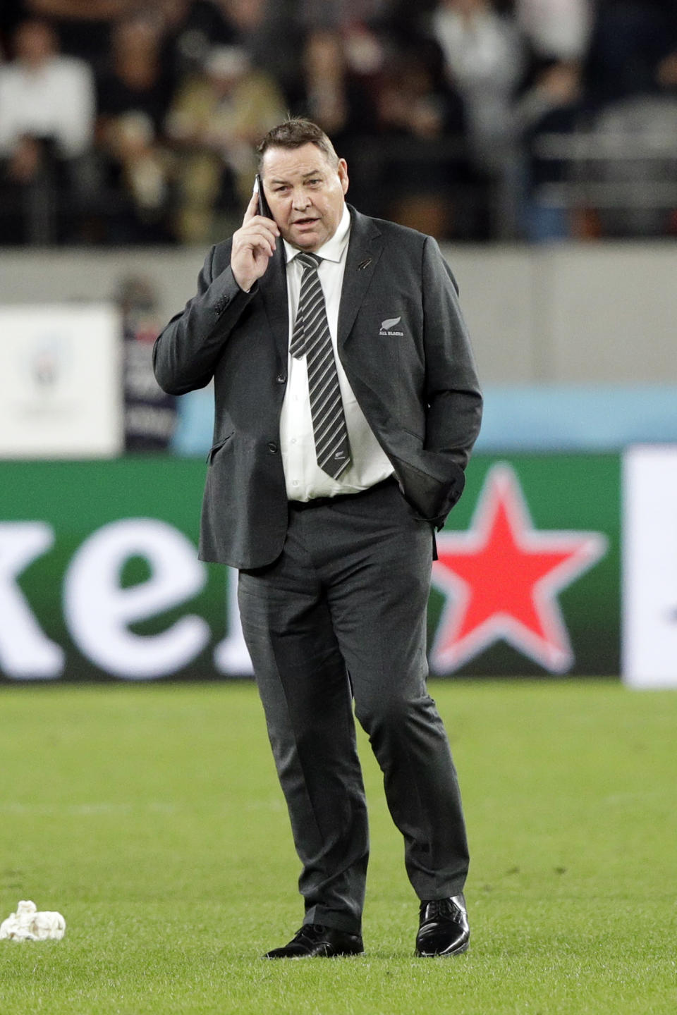 New Zealand coach Steve Hansen gives a phone call after the Rugby World Cup bronze final game at Tokyo Stadium between New Zealand and Wales in Tokyo, Japan, Friday, Nov. 1, 2019. (AP Photo/Mark Baker)
