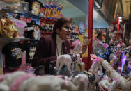 <p>Concessions manager Jeannie Hamilton helps a customer at one of the many memorabilia booths after a show, Saturday, May 6, 2017, in Providence, R.I. While people talk about running away with the circus as freeing, Hamilton said she sometimes felt constrained _ either stuck at the arena or stuck on the train. But Hamilton decided to spend that last trip soaking it all in. “Anytime the train was moving, I was on the vestibule,” she said, referring to the small standing area between train cars. “Now that it’s coming to an end, I was trying to enjoy every minute of it.” (Photo: Julie Jacobson/AP) </p>