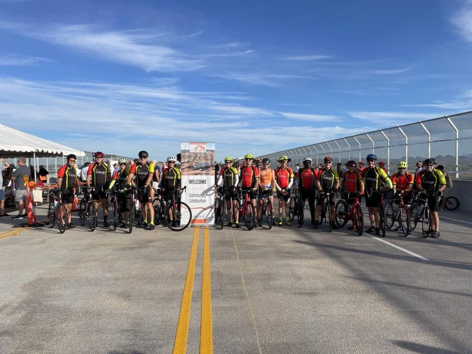 Members of Trilogy bicycle club pose for a photo at the grand opening of the new bridge in far north Peoria. President Gail Johnson, pictured 6th from the left, said the club is excited to have a new road to ride their bicycles.