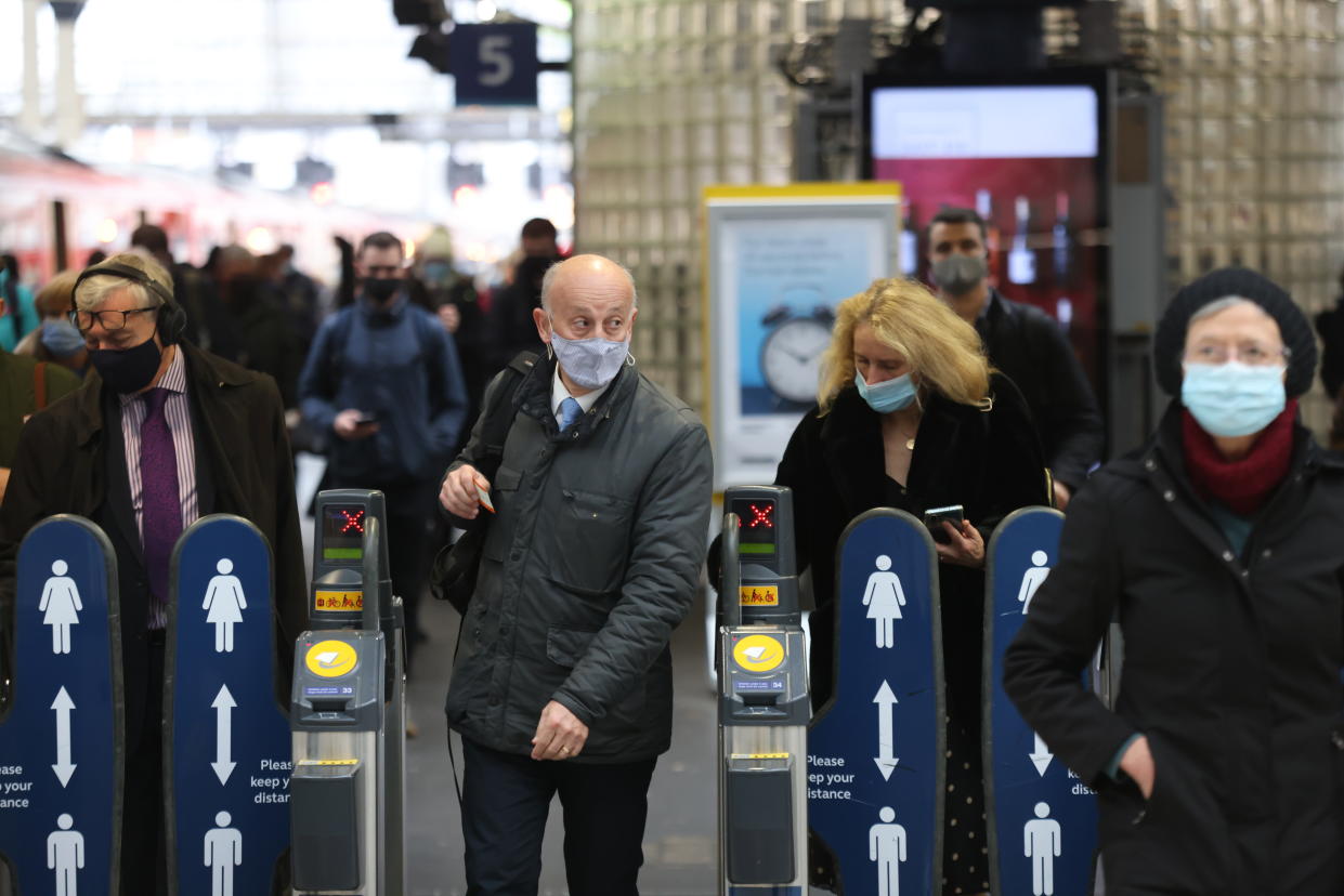 Passengers wearing masks travelling via Waterloo station in London, as mask wearing on public transport becomes mandatory to contain the spread of the Omicron Covid-19 variant. Picture date: Tuesday November 30, 2021.