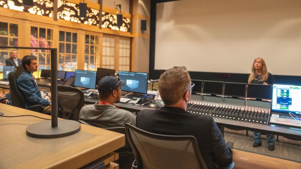 Tech writers seated in Sony Pictures sound mixing studio getting Dolby Atmos demo
