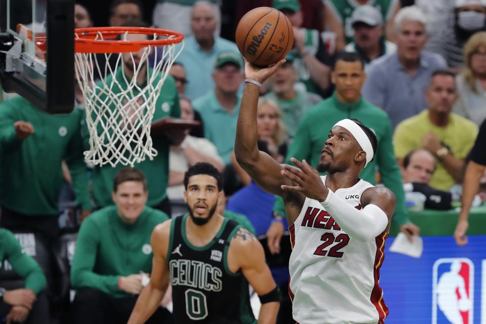 Miami Heat's Jimmy Butler (22) shoots against Boston Celtics' Jayson Tatum (0) during the second half of Game 6 of the NBA basketball playoffs Eastern Conference finals Friday, May 27, 2022, in Boston. (AP Photo/Michael Dwyer)