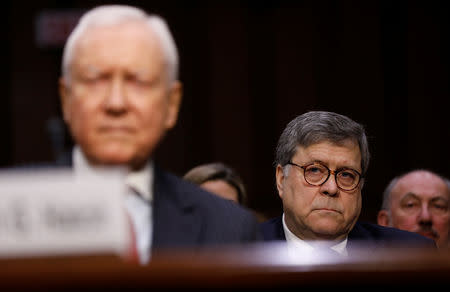 William Barr listens as he sits behind former U.S. Senator Orrin Hatch while waiting to testify at the start of his U.S. Senate Judiciary Committee hearing on his nomination to be attorney general of the United States on Capitol Hill in Washington, U.S., January 15, 2019. REUTERS/Kevin Lamarque