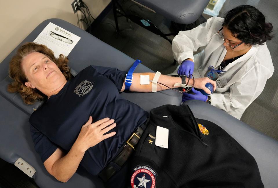 Wendy Luna, a phlebotomist with We Are Blood, takes a donation from paramedic Terri King at Williamson County EMS in Georgetown on Jan. 10. The event kicked off a partnership in which paramedics will have access to units of blood on command vehicles.