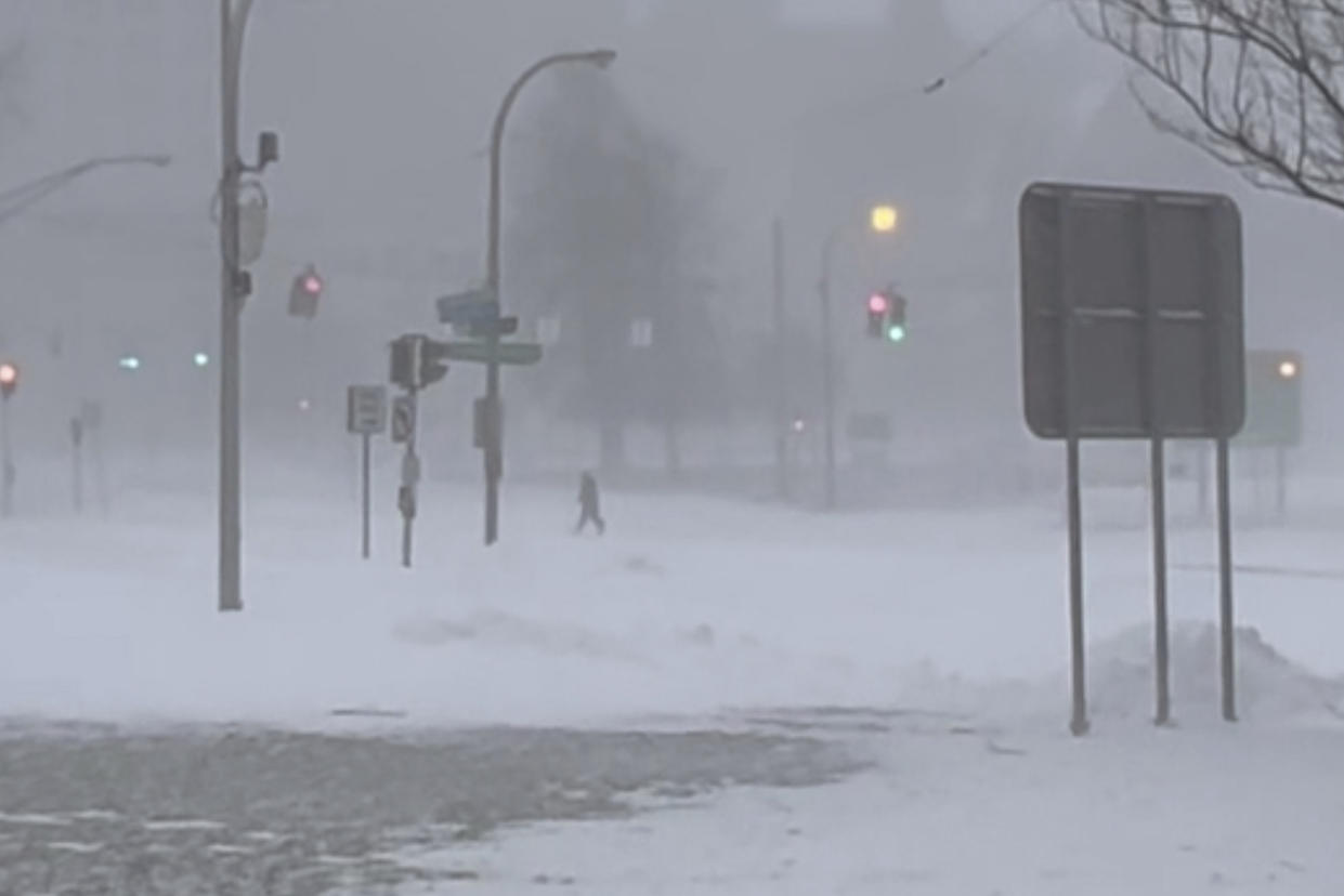 High winds and snow covers the streets and vehicles in Buffalo, N.Y. on Sunday, Dec. 25, 2022. Millions of people hunkered down in a deep freeze overnight and early morning to ride out the frigid storm that has killed at least 20 people across the United States, trapping some residents inside homes with heaping snow drifts and knocking out power to several hundred thousand homes and businesses.(WKBW via AP)