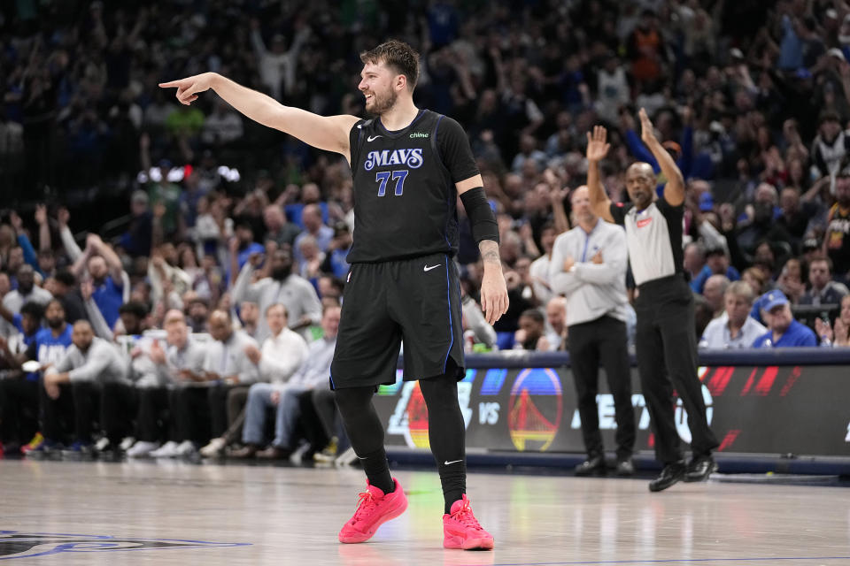 Dallas Mavericks guard Luka Doncic (77) celebrates after sinking a 3-point basket in the second half of an NBA basketball game against the Phoenix Suns in Dallas, Thursday, Feb. 22, 2024. (AP Photo/Tony Gutierrez)