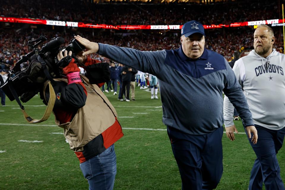 Dallas Cowboys head coach Mike McCarthy pushes a cameraman away while walking off the field after an NFL divisional round playoff football game against the San Francisco 49ers in Santa Clara, Calif., Sunday, Jan. 22, 2023.