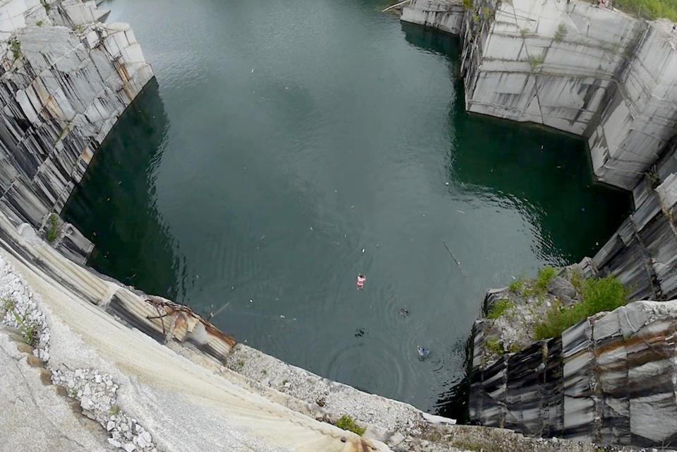 Cliff diver makes huge 34-metre jump into flooded quarry in Vermont