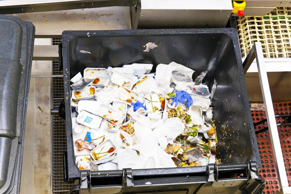 Leftovers of airline food in a large waste container from in-flight service. (Photo: Wicki58 via Getty Images)