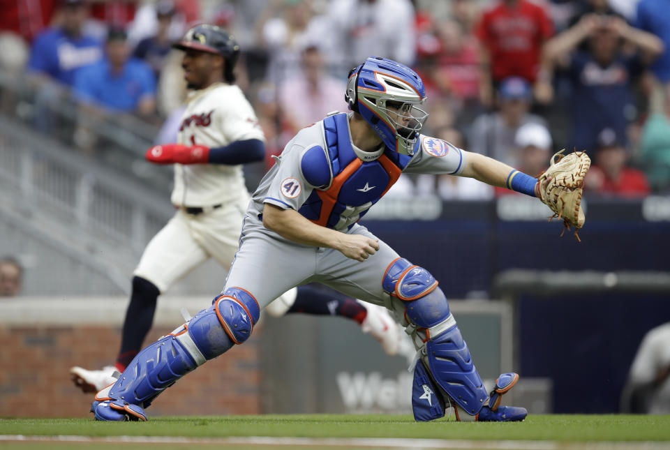 New York Mets catcher Patrick Mazeika waits for the ball as Atlanta Braves' Ozzie Albies scores behind him in the first inning of a baseball game Sunday, Oct. 3, 2021, in Atlanta. (AP Photo/Ben Margot)