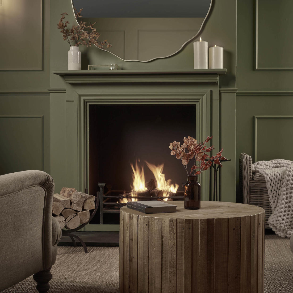  living room with green painted wood panelling and fireplace 