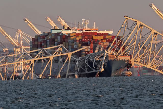 <p>Rob Carr/Getty</p> cargo ship crashes into the Francis Scott Key Bridge on March 26, 2024