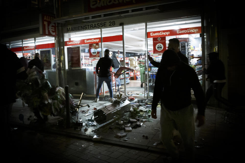 Goods lie on the floor after people broke into a shop on Marienstrasse in Stuttgart, Germany, Sunday, June 21, 2020. Dozens of violent small groups devastated downtown Stuttgart on Sunday night and injured several police officers, German news agency DPA reported. (Julian Rettig/dpa via AP)