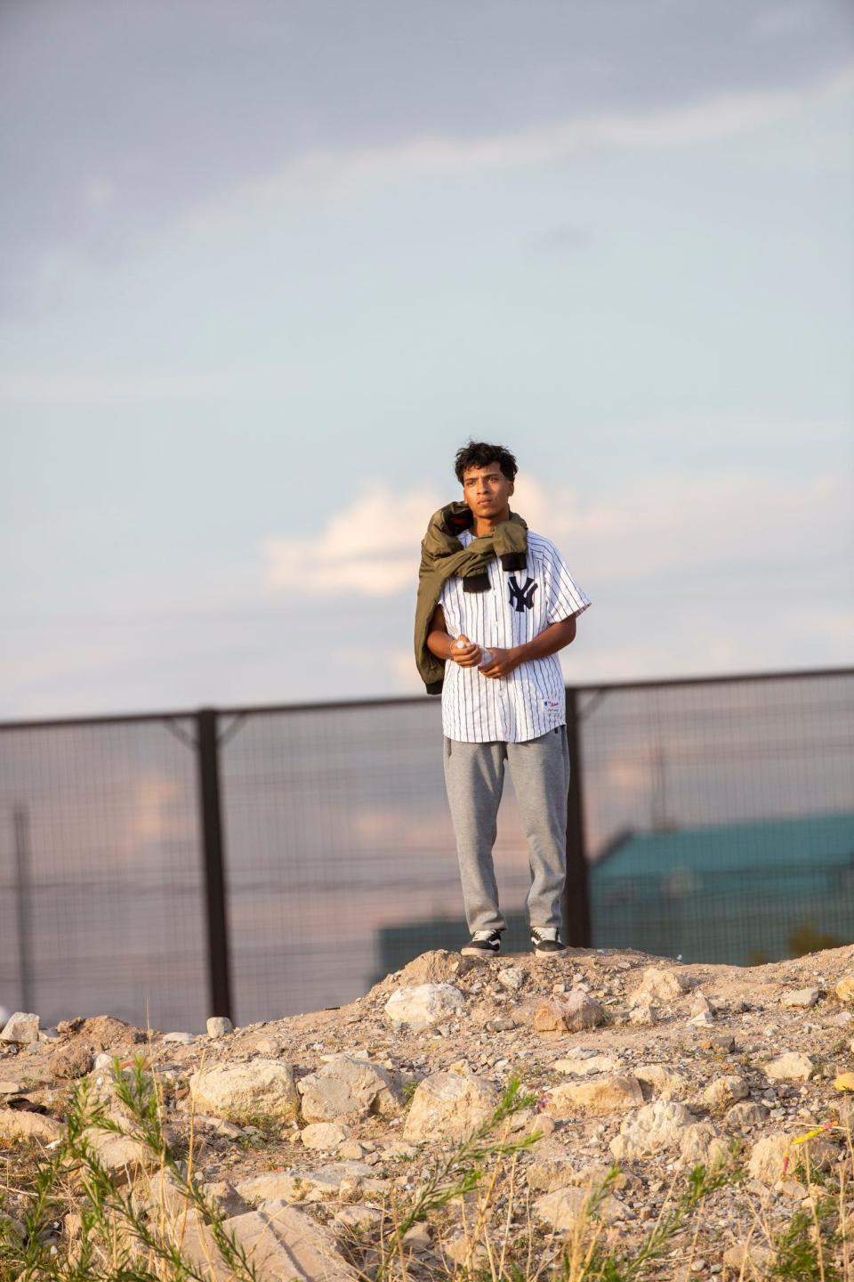 A Venezuelan migrant stands near the Paisano overpass as he waits for processing by Customs and Border Protection. Some migrants awaited for up to seven hours, then returned to Juárez to purchase water and food.