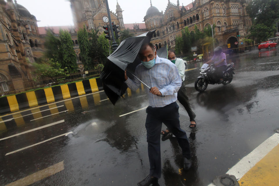 People hold umbrellas during a thunderstorm and heavy rains in Mumbai, India on June 03, 2020. Tropical cyclone storm "Nisarga" expected to hit the Maharashtra coast on Wednesday as per media report. (Photo by Himanshu Bhatt/NurPhoto via Getty Images)