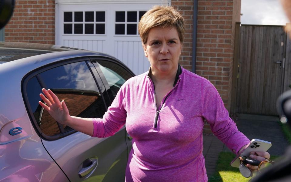 Nicola Sturgeon is pictured today talking to the media outside her Glasgow home