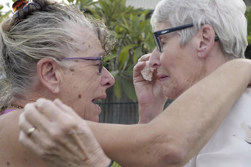 Christine Archer, right, and her sister Gail Baker cry as they are reunited in Bowraville, Australia Wednesday, May 20, 2020. Australia had rejected Archer’s request for permission to fly from New Zealand four times before her story attracted media attention. Her only sister Baker was diagnosed with incurable ovarian cancer in late March after both countries stopped international travel. Baker has perhaps weeks to live. Archer was eventually allowed to fly to Sydney and spent only a week in hotel quarantine before testing negative for the coronavirus. (AuBC via AP)