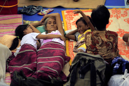 Evacuees from the coastal villages take shelter inside an evacuation center as Typhoon Haima locally name Lawin approaches, in Alcala town, Cagayan province, north of Manila October 19, 2016. REUTERS/Stringer