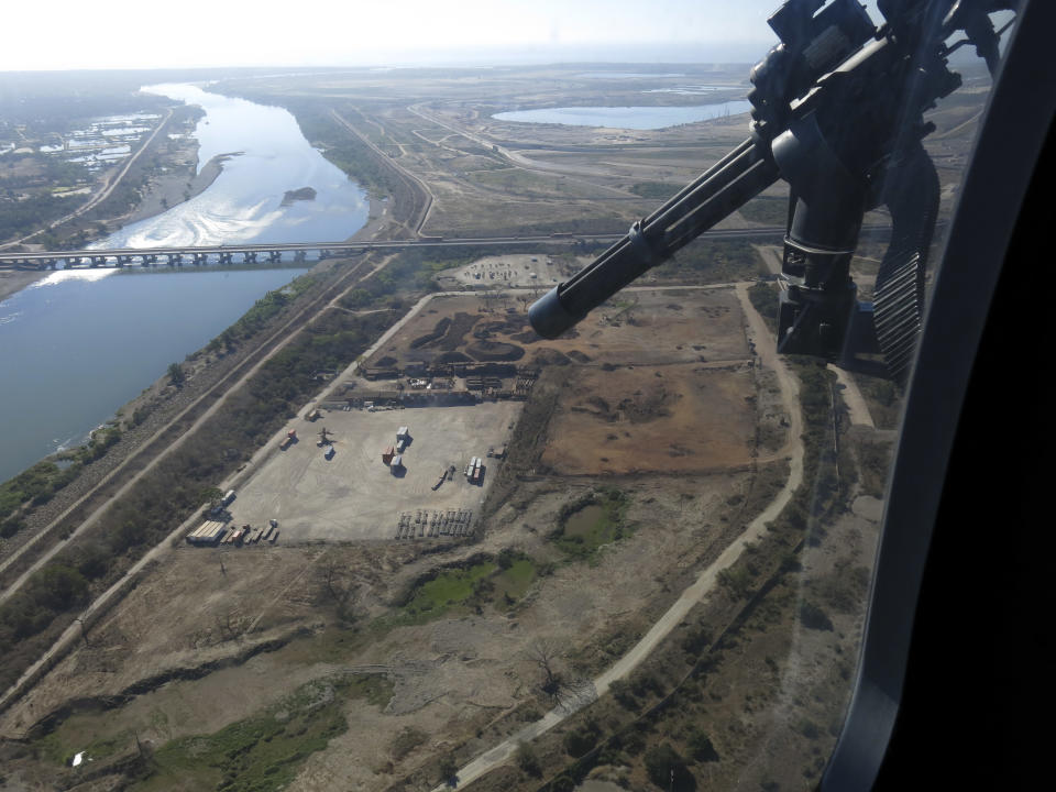 In this March 12, 2014, Mexican federal police fly over the Balsas River near the Pacific port of Lazaro Cardenas, Mexico. Alonso Ancira, president of the National Chamber of the Iron and Steel, told local media that drug cartels earned $1 billion in profits in 2013 from the sale of iron ore, according to his estimates. By 2012 nearly half of the iron ore exports to China went through the port of Lazaro Cardenas. The federal government took over the port of Lazaro Cardenas in November 2013. (AP Photo/Eduardo Castillo)