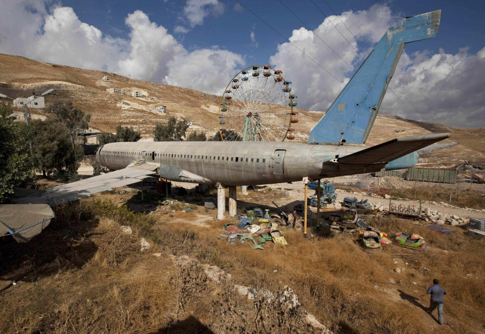 FILE - In this Oct. 6, 2009 file photo, an old Boeing 707 awaits conversion to a restaurant and cafe, near the west bank town of Nablus. The territory has no civilian airport and those who can afford a plane ticket must catch their flights in neighboring Jordan. After a quarter century of effort, twins brothers, Khamis al-Sairafi and Ata, opened “The Palestinian-Jordanian Airline Restaurant and Coffee Shop al-Sairafi” on July 21, 2021, offering people an old airplane for customers to board. (AP Photo/Oded Balilty, File)