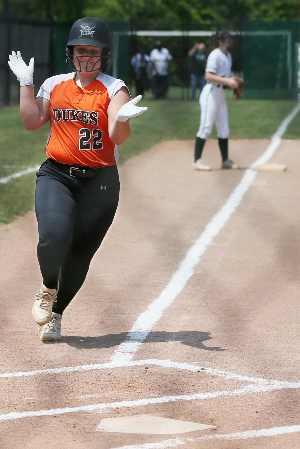 Marlington's Audrey Miller claps as she scores the first of two runs on a hit by Ava Collins against St. Vincent-St. Mary during a regional semifinal Nordonia on Wednesday.