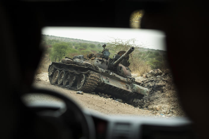 FILE - A destroyed tank is seen by the side of the road south of Humera in western Tigray, then annexed by the Amhara region, in Ethiopia, May 1, 2021. A year after war began there, the findings of the only human rights investigation allowed in Ethiopia's blockaded Tigray region will be released Wednesday, Nov. 3, 2021. (AP Photo/Ben Curtis, File)