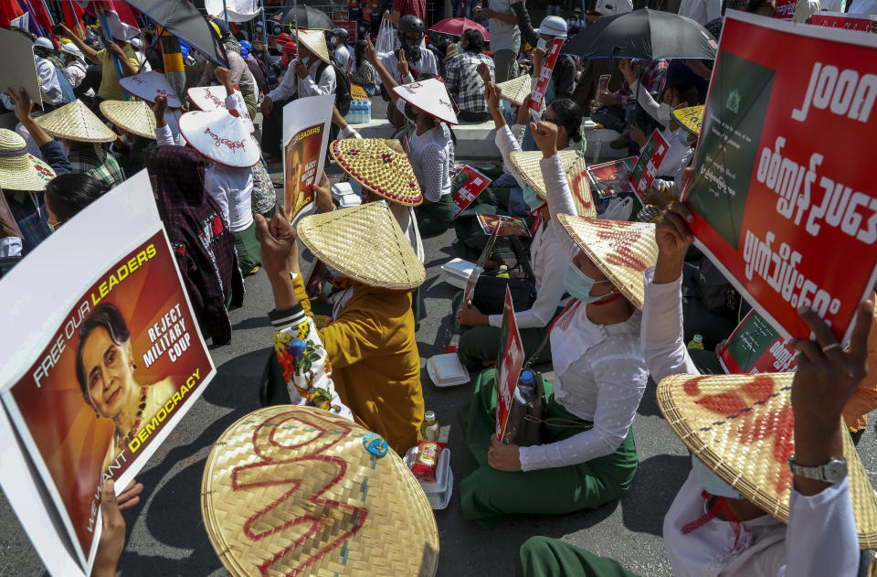 Anti-coup protesters stage a sit-in protest after riot policemen blocked their march in Mandalay, Myanmar, Wednesday, Feb. 24, 2021. Protesters against the military's seizure of power in Myanmar were back on the streets of cities and towns on Wednesday, days after a general strike shuttered shops and brought huge numbers out to demonstrate. (AP Photo)