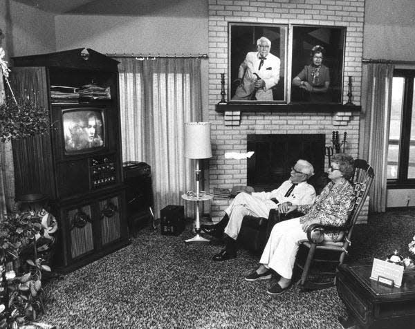 Col. Sanders and his wife, Claudia, enjoy a quiet moment in their home. C-J file photo