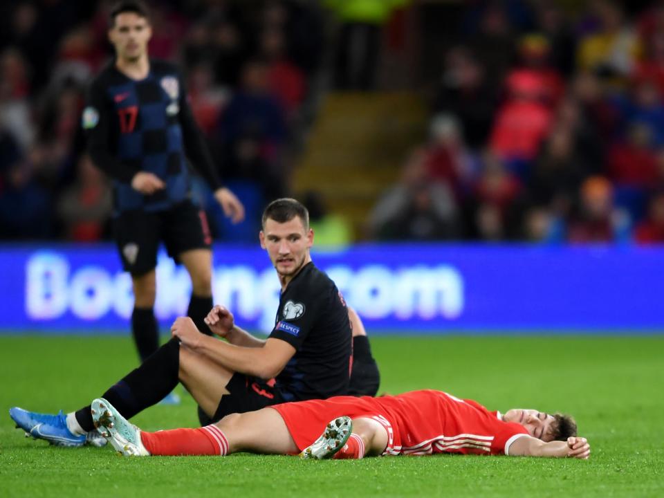 Daniel James appeared to be knocked out after clashing heads with Croatia's Domagoj Vida: Getty