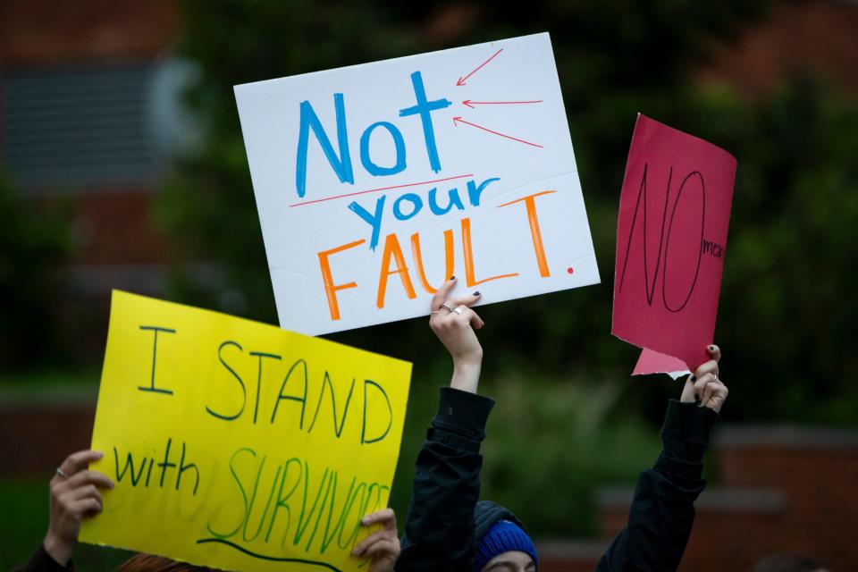 Marchers take to the streets of Eugene carrying signs of support during Take Back the Night Thursday, April 25, 2024, in Eugene, Ore.