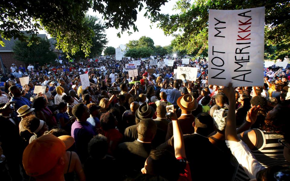 Hundreds of protestors rally against what demonstrators call police brutality in McKinney, Texas June 8, 2015. Hundreds marched through the Dallas-area city of McKinney on Monday calling for the firing of police officer Eric Casebolt, seen in a video throwing a bikini-clad teenage girl to the ground and pointing his pistol at other youths at a pool party disturbance. REUTERS/Mike Stone