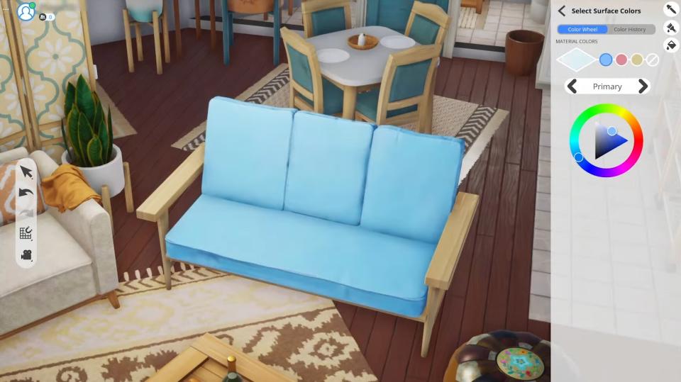 The Sims 5, Project Rene in development screenshot of a blue couch with a color wheel panel open.