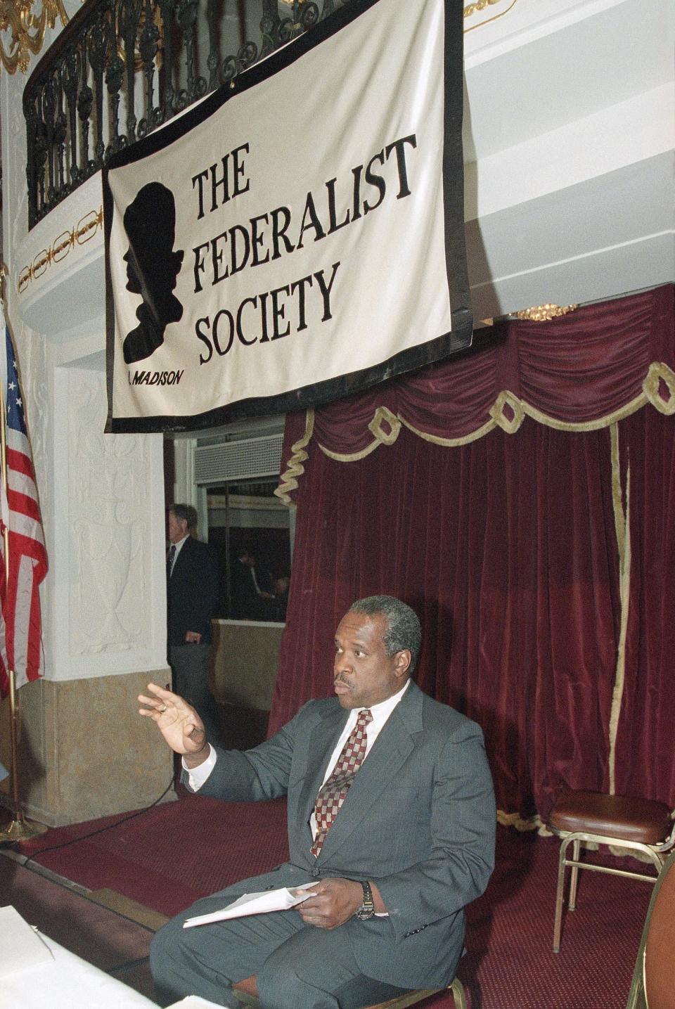 Supreme Court Justice Clarence Thomas gestures prior to addressing the Federalist Society's national meeting in Washington, Sept. 22, 1995.