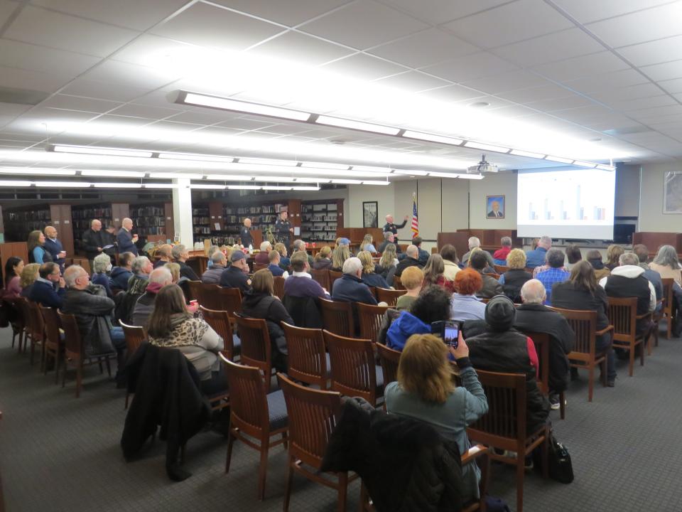 Police Sgt. Chris Somjen makes a presentation on auto theft statistics during a town hall at Mountain Lakes high School with Morris County Prosecutor Robert Carroll.