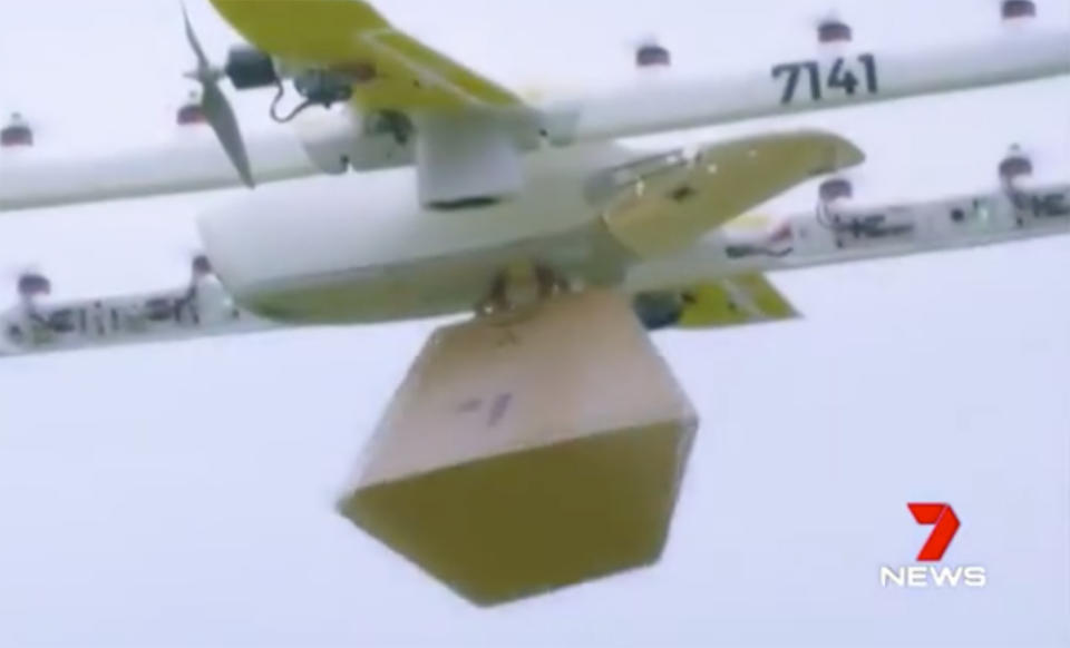 A drone carrying a cardboard package