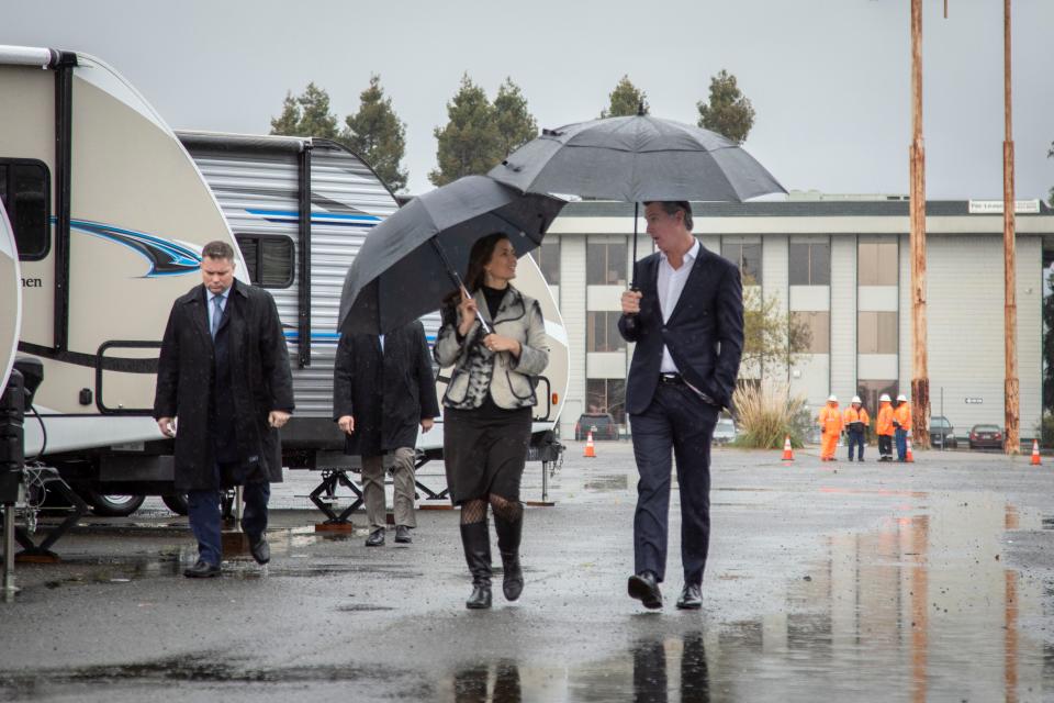 Oakland Mayor Libby Schaaf and California Governor Gavin Newsom tour a new site where the state will provide emergency housing for the homeless in Oakland, Calif.