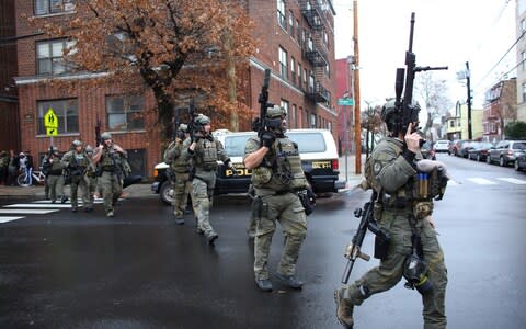 Two suspects were barricaded in a convenience store - Credit: KENA BETANCUR/AFP