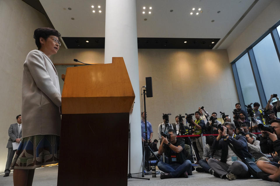 Hong Kong Chief Executive Carrie Lam, left, speaks during a press conference in Hong Kong, Tuesday, Nov. 26, 2019. Lam has refused to offer any concessions to anti-government protesters after a local election setback. (AP Photo/Vincent Yu)