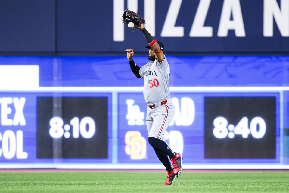 Minnesota Twins outfielder Willi Castro (50) fields a hit by Toronto Blue Jays Ernie Clement (28) during the seventh inning of a baseball game, Saturday, May 11, 2024, in Toronto. (Chris Katsarov/The Canadian Press via AP)