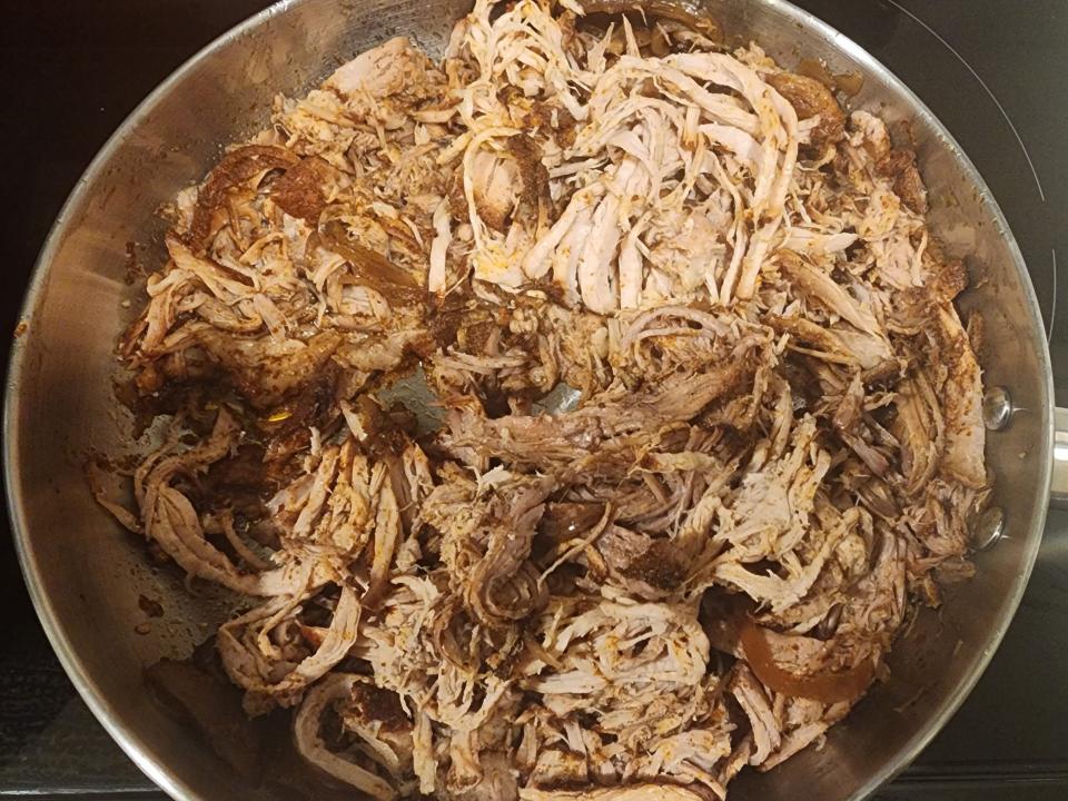 Shredded pork in a pan.