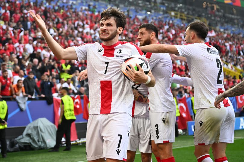 Khvicha Kvaratskhelia (L) celebrates the team's first goal during the UEFA Euro 2024 Group F football match between Turkey and Georgia at the BVB Stadion in Dortmund on June 18, 2024.