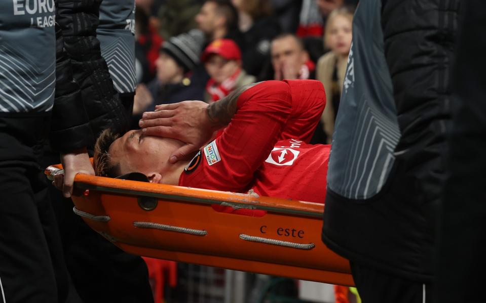 Lisandro Martinez leaves the pitch on a stretcher against Sevilla - Lisandro Martinez could miss rest of the season with 'metatarsal break' - Getty Images/Matthew Peters