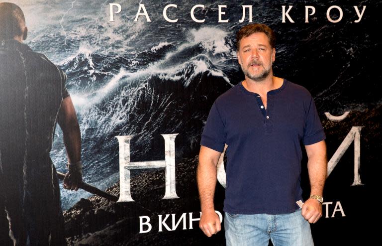 Actor Russell Crowe pictured with a billboard for his new film "Noah" in Moscow on March 17, 2014