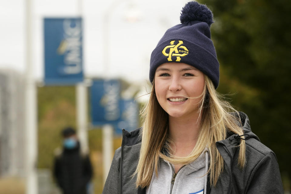 Madison Zurmuehlen poses for a photo on the University of Missouri-Kansas City campus in Kansas City, Mo., Friday, Oct. 23, 2020. Amid pandemic restrictions aimed at keeping students safe and healthy, colleges are scrambling to help them adjust. Zurmuehlen said daily practices, with masks, are “the one thing I look forward to,” so it was tough when campus sports were canceled for two weeks after an outbreak among student athletes and staff. (AP Photo/Orlin Wagner)