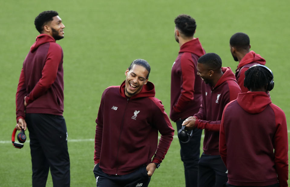 Liverpool's Virgil van Dijk, second left, laughs next to teammates at the Camp Nou stadium in Barcelona, Spain, Tuesday, April 30, 2019. FC Barcelona will play against Liverpool in a first leg semifinal Champions League soccer match on Wednesday, May 1. (AP Photo/Manu Fernandez)