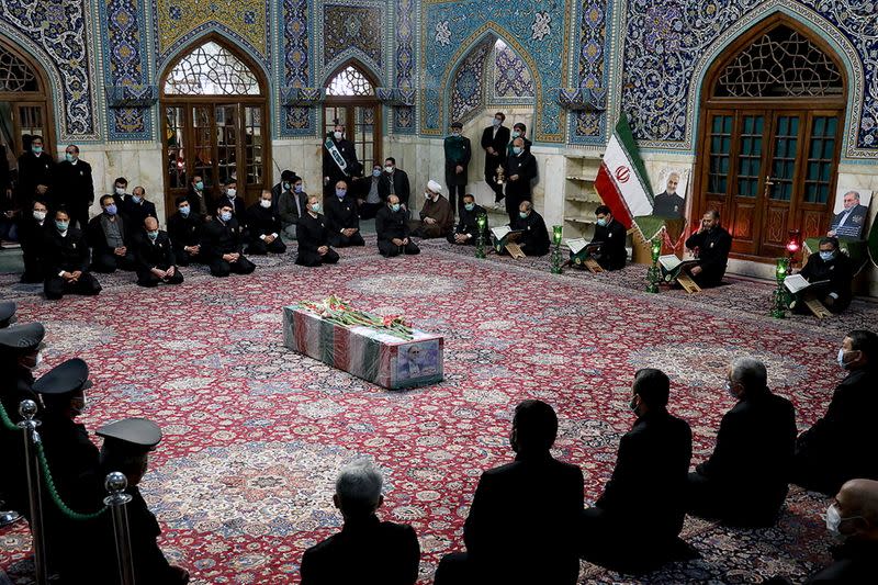 A coffin with an image of Iranian nuclear scientist Mohsen Fakhrizadeh, can be seen among the servants of the holy shrine of Imam Reza in Mashhad