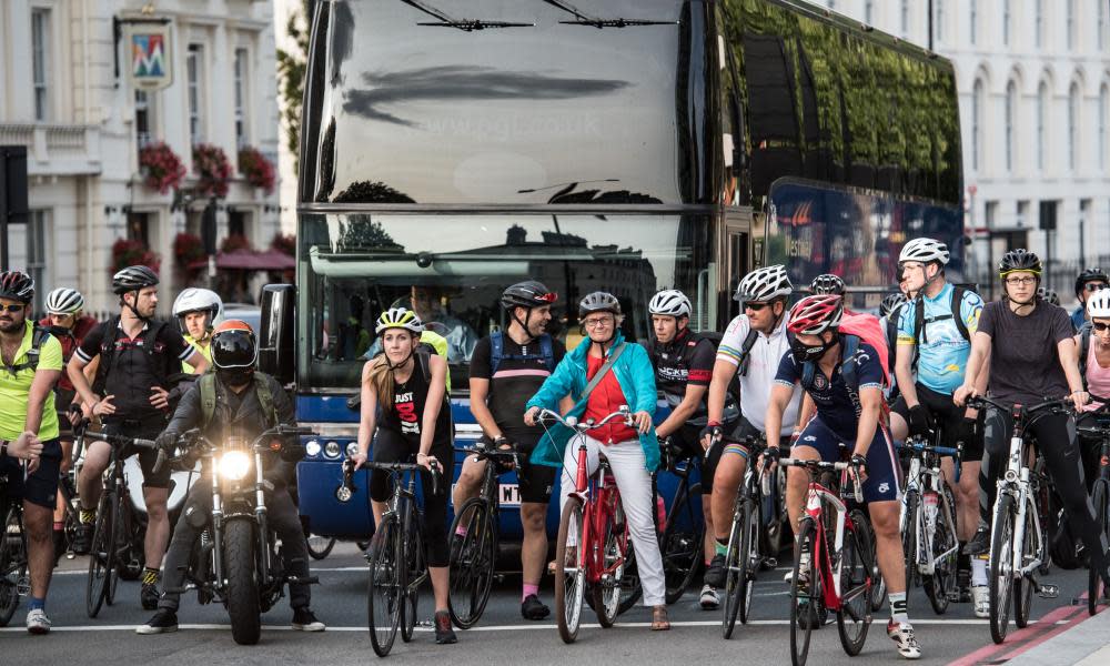 Cyclists wait at traffic lights in London.