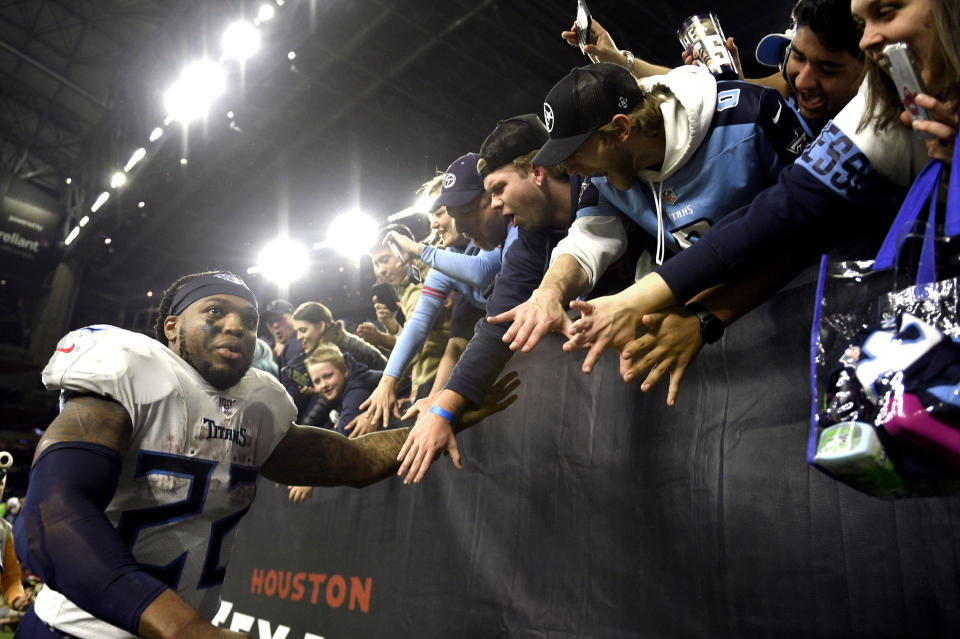Tennessee Titans running back Derrick Henry (22) celebrates with fans after an NFL football game against the Houston Texans Sunday, Dec. 29, 2019, in Houston. Henry moved into first place for the season rushing title on a 53-yard touchdown run during the fourth quarter. The Titans won 35-14. (AP Photo/Eric Christian Smith)