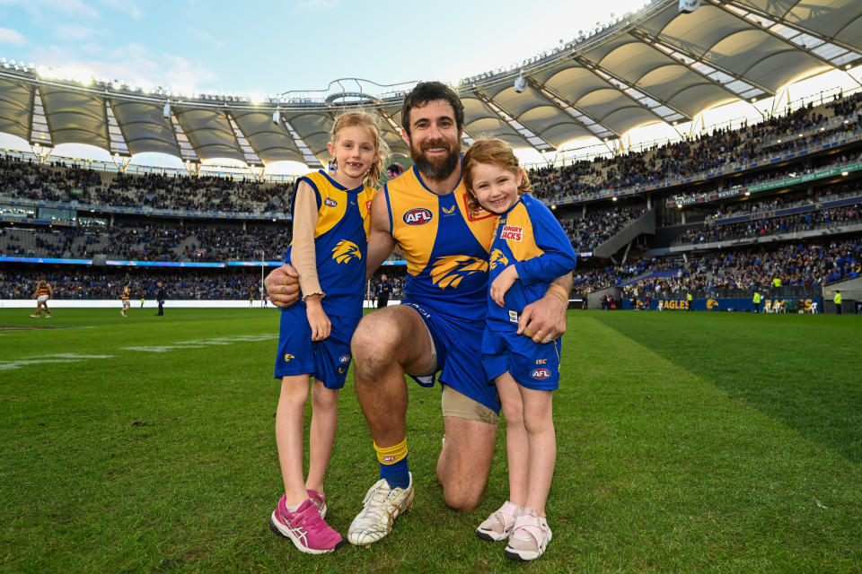 Josh Kennedy, pictured here posing for a photo with his daughters after his final match in the AFL.